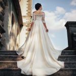 Beautiful bride in a gorgeous wedding dress from the designer against the background of the medieval castle